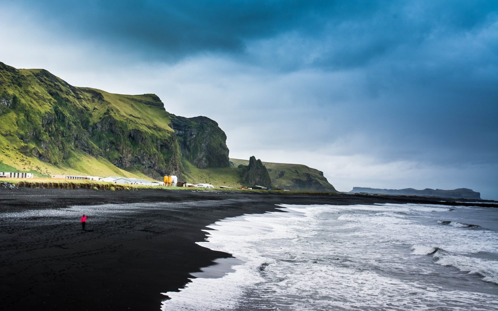 the black sand beaches in hawaii are comprised of ________.